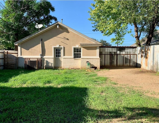 rear view of property with a yard