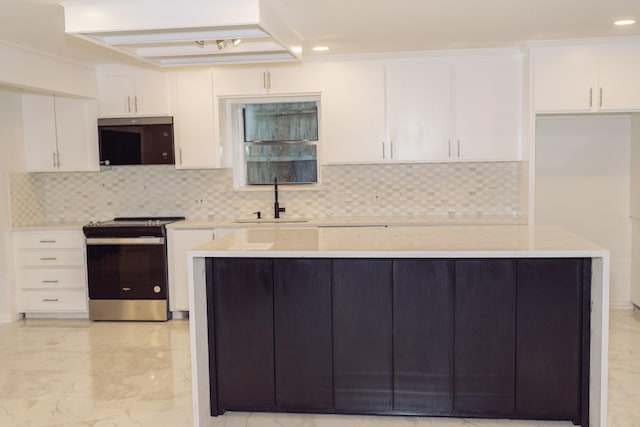 kitchen with white cabinetry, stainless steel electric range oven, sink, and decorative backsplash