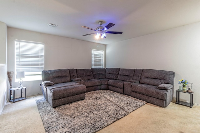 living room featuring light carpet and ceiling fan