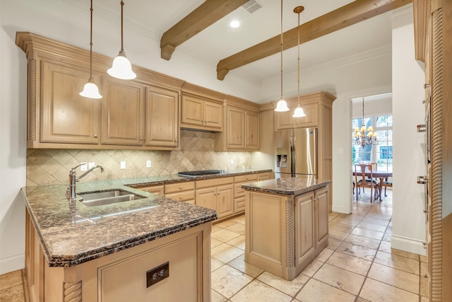 kitchen with pendant lighting, sink, stainless steel appliances, a center island, and light brown cabinetry