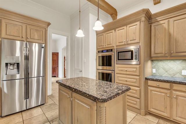 kitchen featuring appliances with stainless steel finishes, a kitchen island, pendant lighting, dark stone counters, and decorative backsplash