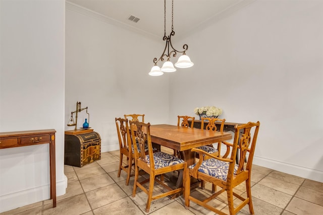 dining space featuring light tile patterned flooring, ornamental molding, and a chandelier