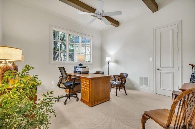 office space with beamed ceiling, ornamental molding, light carpet, and ceiling fan