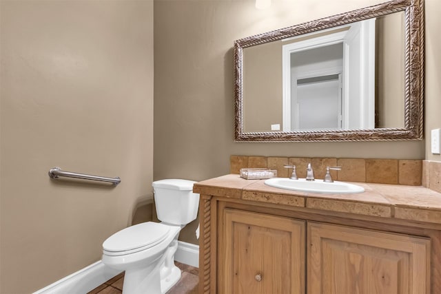 bathroom featuring vanity, toilet, and tile patterned flooring