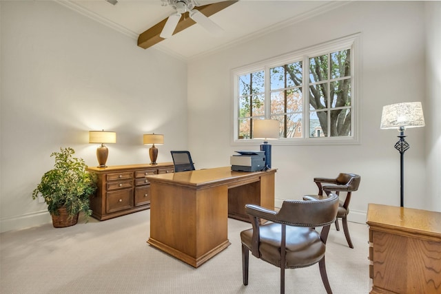 carpeted home office with beamed ceiling, ornamental molding, and ceiling fan