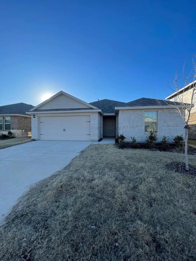 ranch-style house featuring a garage and a front lawn