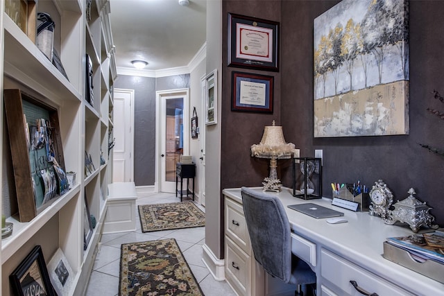 office area with ornamental molding, built in desk, and light tile patterned floors