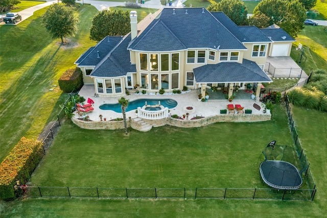 back of property with a swimming pool with hot tub, a gazebo, and a patio