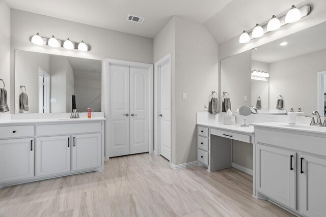 bathroom featuring vaulted ceiling, vanity, and separate shower and tub