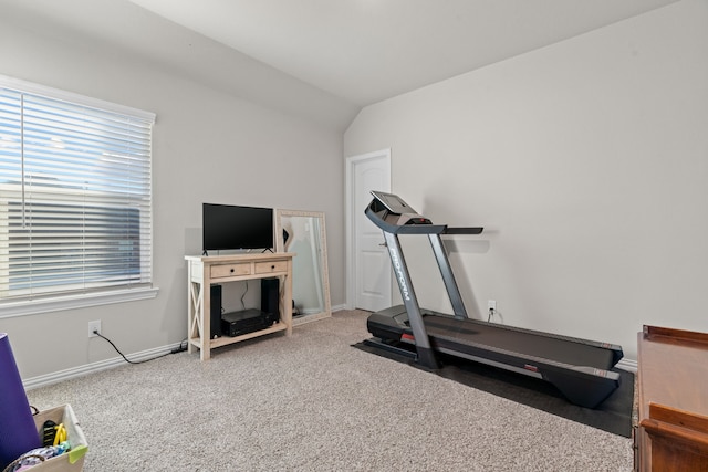 exercise room featuring lofted ceiling and carpet flooring