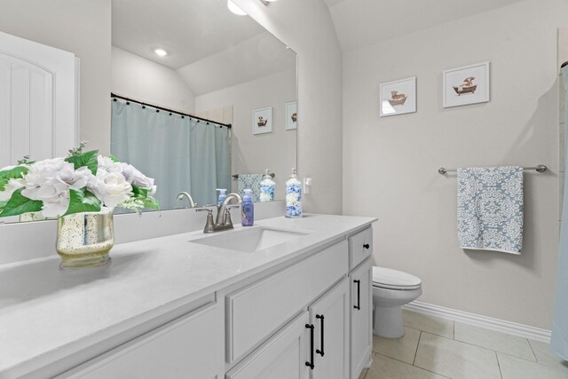 bathroom featuring tile patterned floors, toilet, and vanity