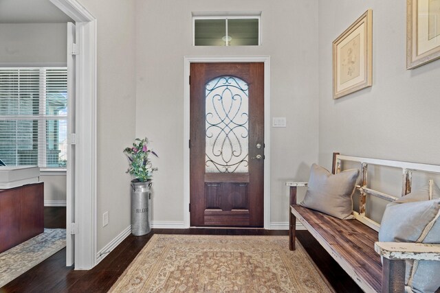 entrance foyer featuring crown molding and dark hardwood / wood-style floors