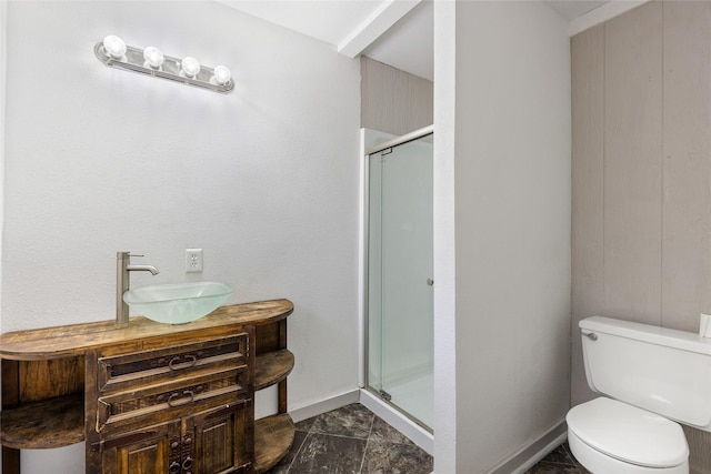 bathroom featuring vanity, toilet, and an enclosed shower