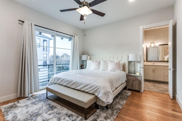 bedroom with ensuite bathroom, sink, access to outside, light wood-type flooring, and ceiling fan