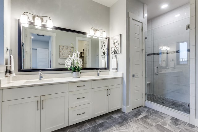 bathroom with a shower with door and vanity