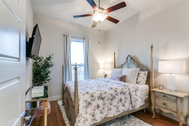 bedroom with ceiling fan and dark hardwood / wood-style flooring