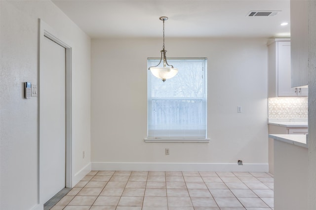 unfurnished dining area with light tile patterned floors