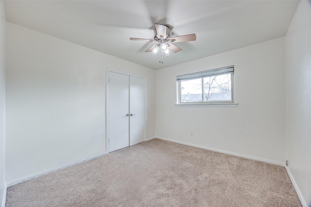 carpeted empty room with ceiling fan