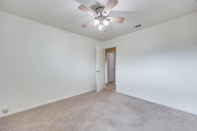 empty room featuring light carpet and ceiling fan