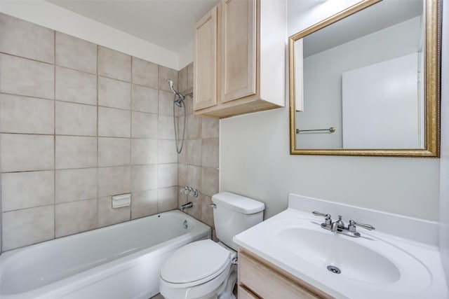 full bathroom featuring tiled shower / bath combo, vanity, and toilet