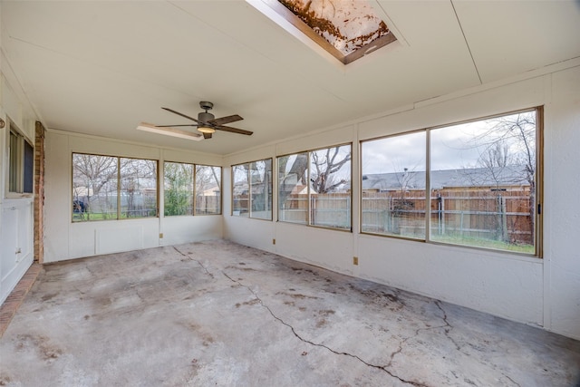 unfurnished sunroom featuring ceiling fan