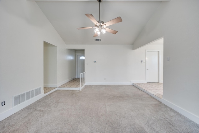 spare room with ceiling fan, high vaulted ceiling, and light carpet