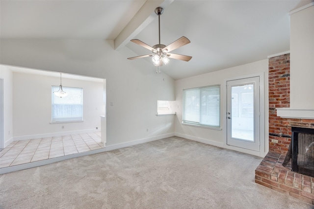 unfurnished living room with light colored carpet, a healthy amount of sunlight, a fireplace, and vaulted ceiling with beams