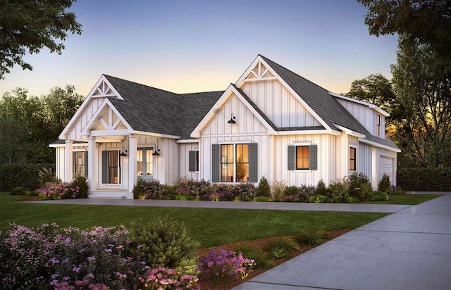 modern farmhouse style home with a garage and a lawn