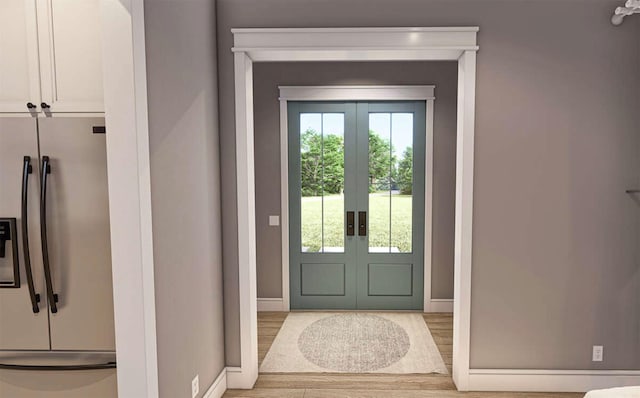 doorway with light hardwood / wood-style flooring and french doors