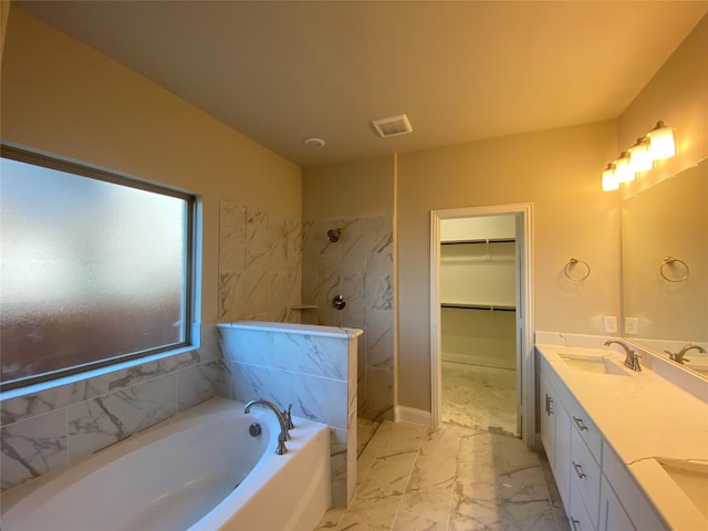 bathroom featuring vanity and shower with separate bathtub