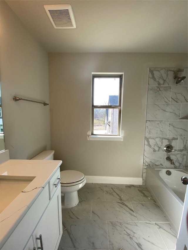 full bathroom featuring vanity, toilet, and tiled shower / bath combo