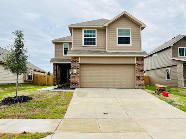 view of front of property featuring a garage and a front yard