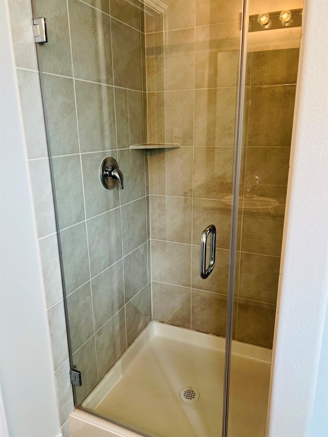 bathroom with a shower with door