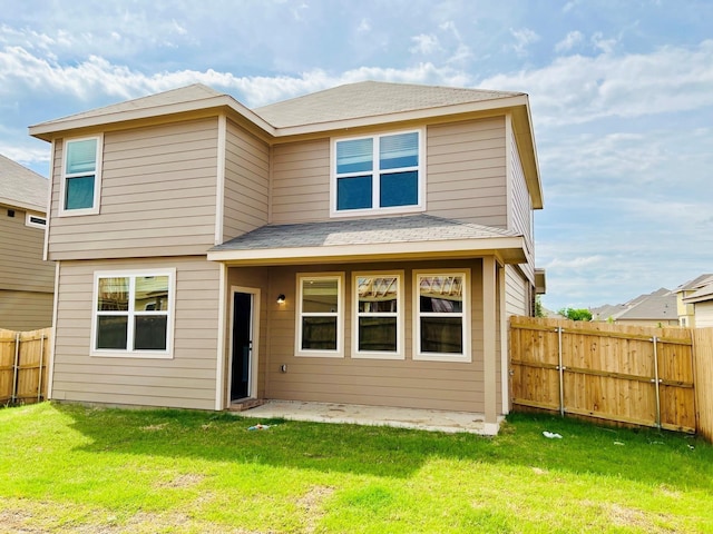 rear view of property featuring a lawn