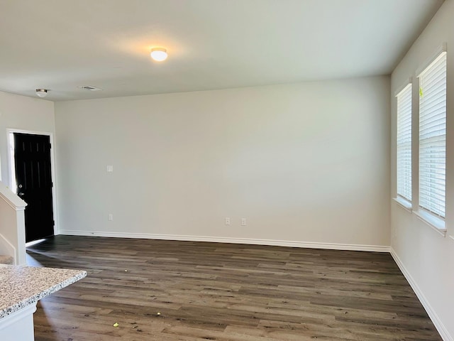 empty room with dark hardwood / wood-style floors