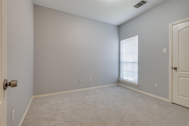 spare room featuring light colored carpet