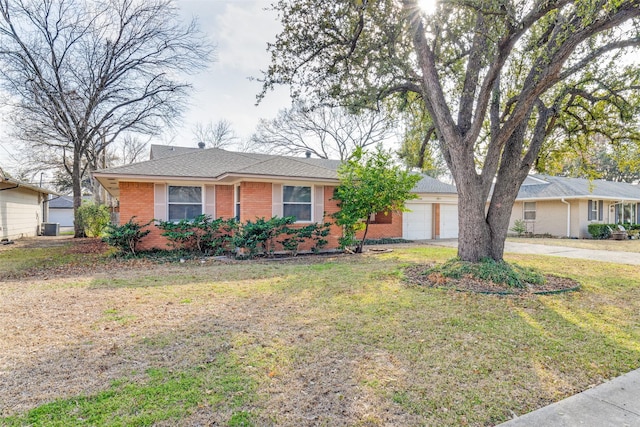 ranch-style house featuring a garage and a front lawn