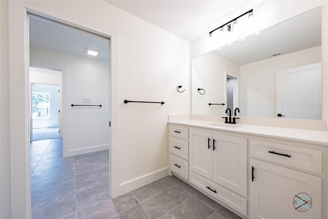 bathroom featuring tile patterned flooring and vanity