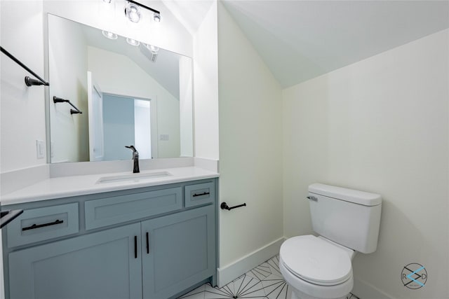 half bathroom featuring vanity, vaulted ceiling, toilet, and baseboards