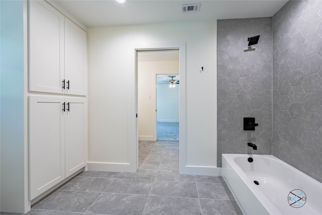 bathroom with tile patterned floors, visible vents, baseboards, and shower / tub combination