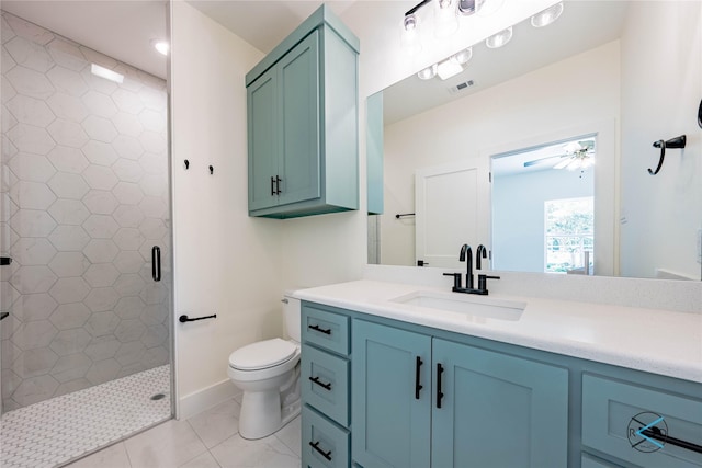 bathroom with vanity, tiled shower, ceiling fan, and toilet