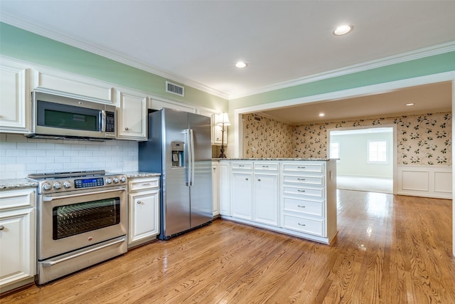 kitchen featuring white cabinetry, light hardwood / wood-style floors, stainless steel appliances, crown molding, and light stone countertops