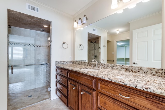 bathroom featuring vanity, tile patterned floors, ornamental molding, and walk in shower