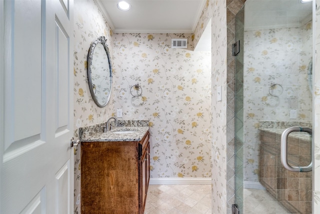 bathroom with crown molding, an enclosed shower, and vanity