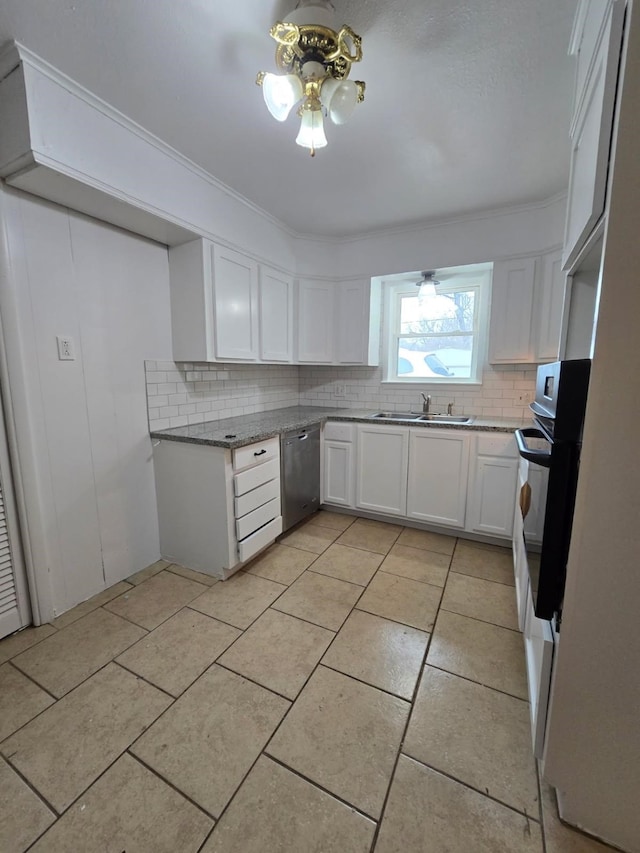 1714 Laurel Rd, Gainesville, TX 76240 - kitchen with stainless steel dishwasher, decorative backsplash, white cabinets, and light tile patterned floors
