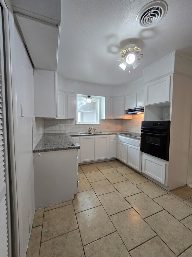 1714 Laurel Rd, Gainesville, TX 76240 - kitchen featuring black appliances, backsplash, ceiling fan, white cabinets, and a textured ceiling