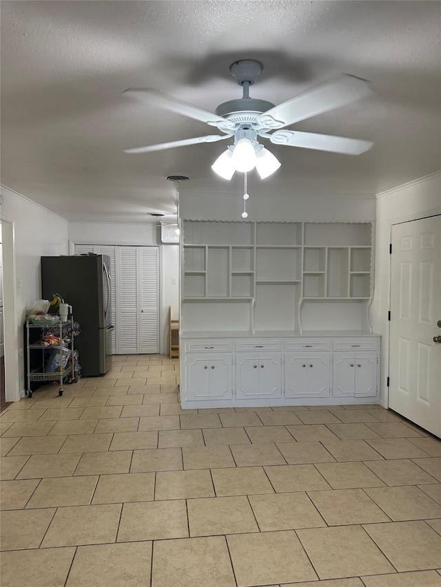 1714 Laurel Rd, Gainesville, TX 76240 - spare room featuring a ceiling fan, crown molding, and a textured ceiling