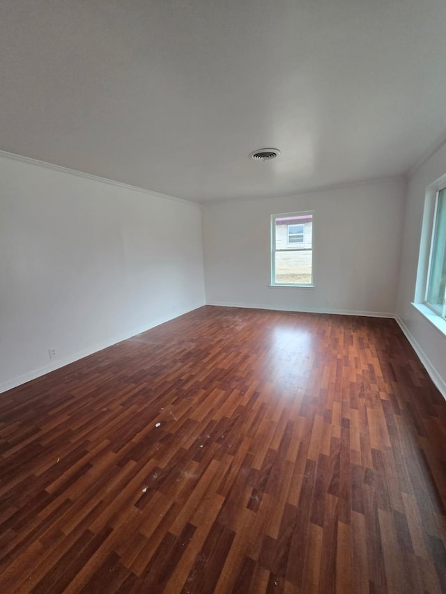 1714 Laurel Rd, Gainesville, TX 76240 - spare room featuring dark wood-style flooring, baseboards, and ornamental molding