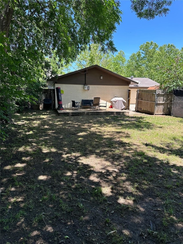 1714 Laurel Rd, Gainesville, TX 76240 - rear view of house featuring concrete block siding and a deck