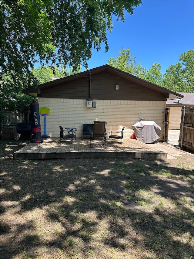 1714 Laurel Rd, Gainesville, TX 76240 - rear view of house with brick siding and a wooden deck